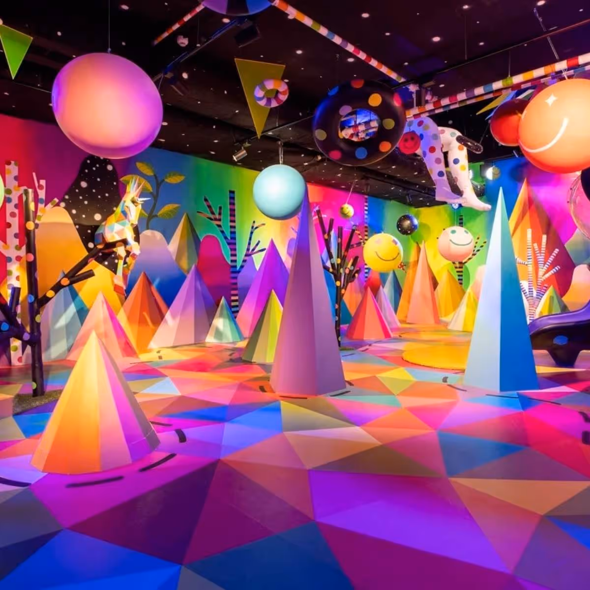 Colourful space with geometric shapes, balloons and abstract trees